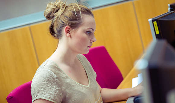 A ҹɫֱ student working alone at their computer desk, Edinburgh