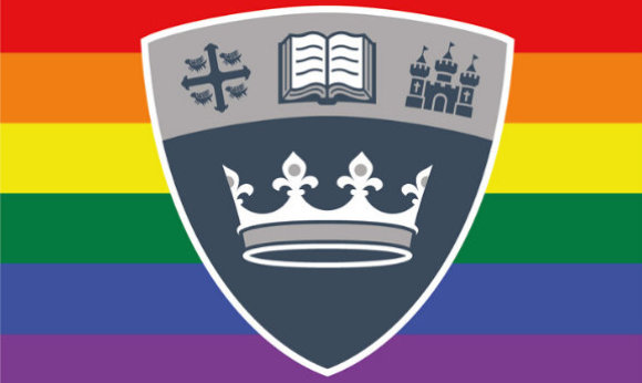 The ҹɫֱ shield in front of the LGBTQ+ flag